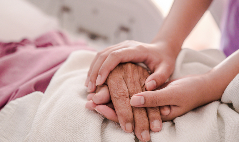 Health care professional holding patient's hand