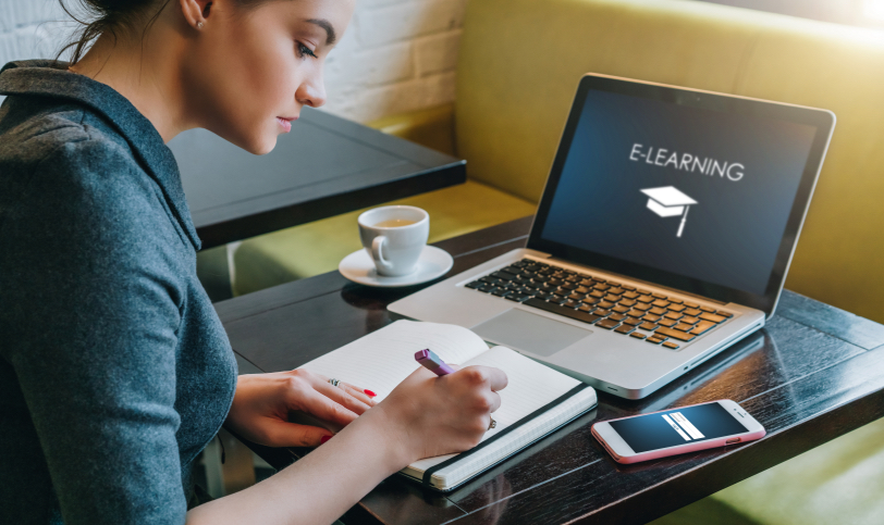 Student studying with laptop showing an e-learning course